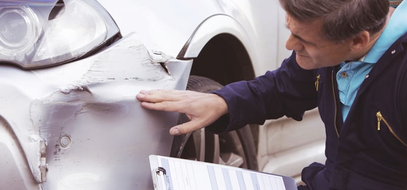 06_2018CollisionCenterAdjuster.jpg Photo of a West Michigan Body Shop professional at Borgman inspecting a damaged vehicle after a car accident