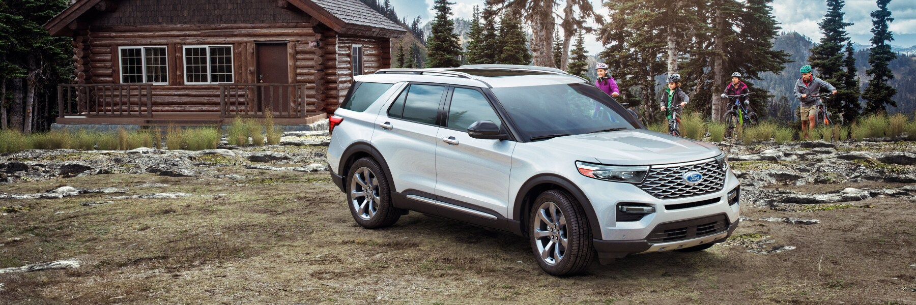 New Ford Explorer with a family in the mountains biking