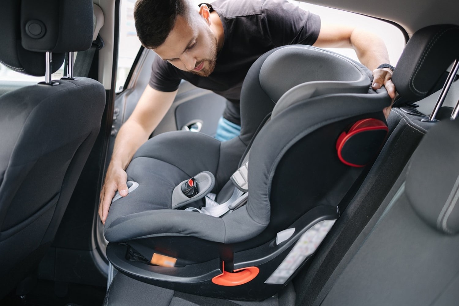 Dad installing carseat in Hyundai