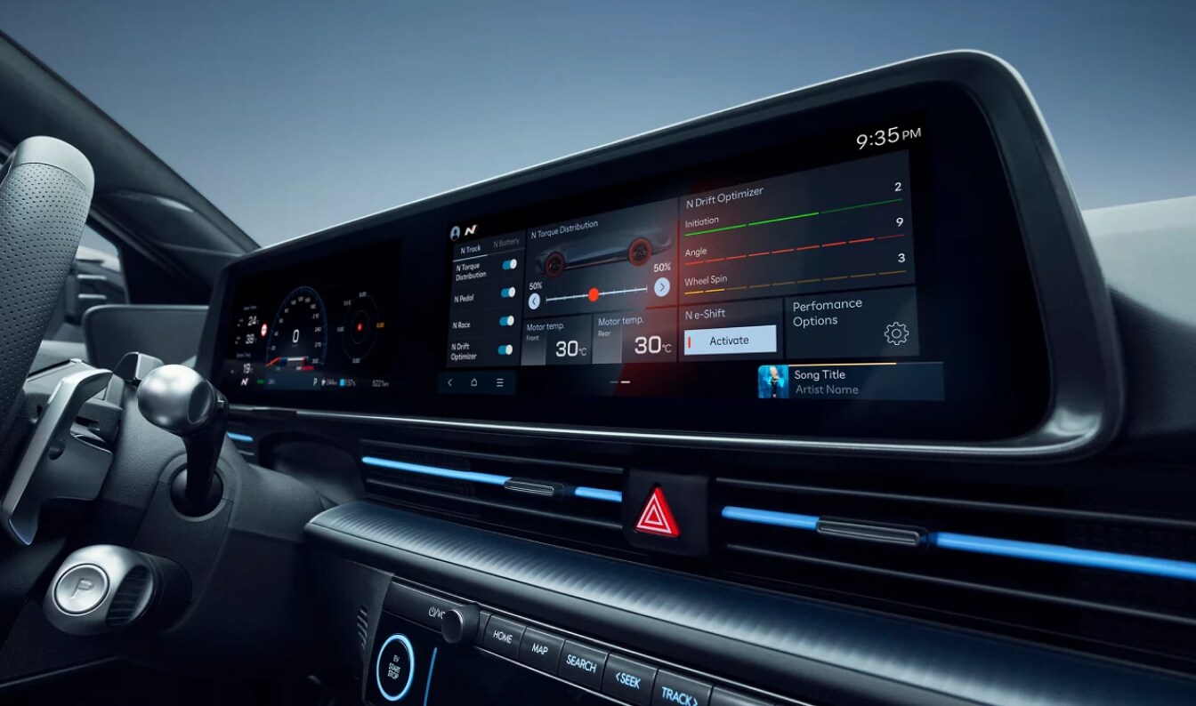 A wide angle close-up shot of IONIQ 6 touchscreen navigation and infotainment system.