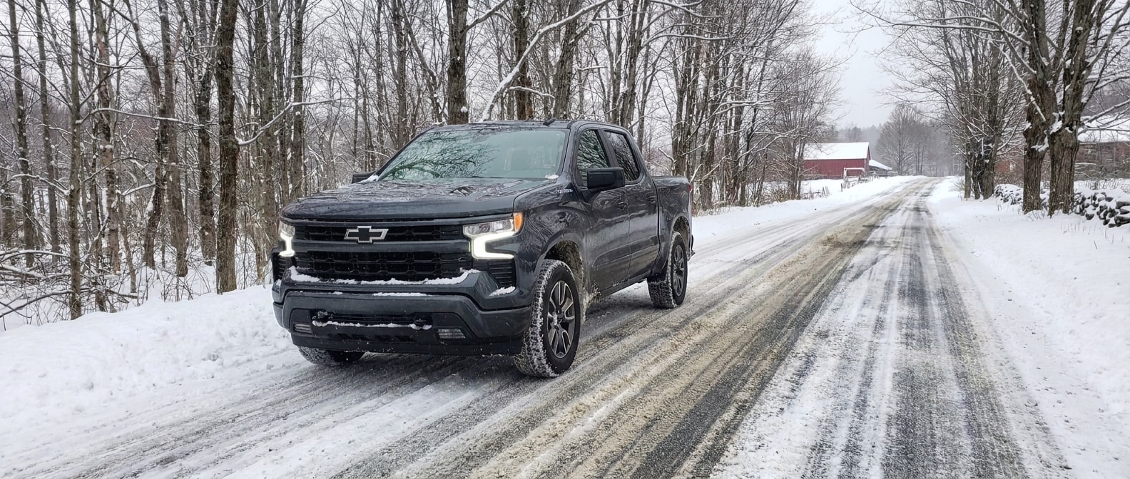 2026 Chevrolet Silverado 1500 driving a snow-covered Vermont two-lane road in winter