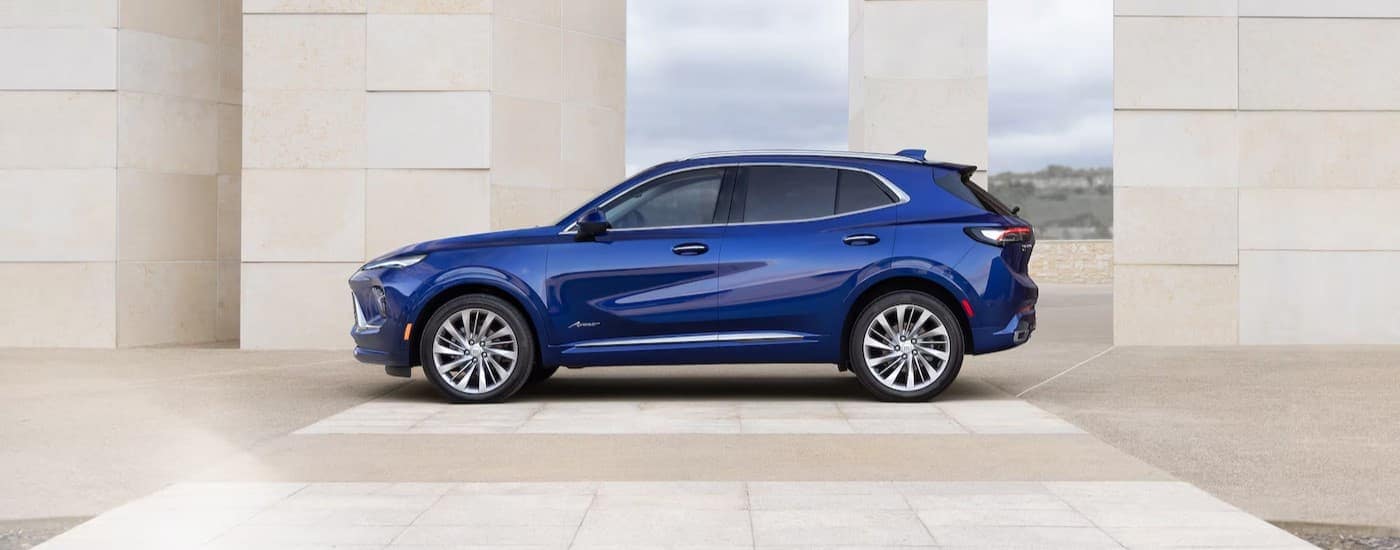 A blue 2025 Buick Envision Avenir parked at a Buick dealer near Hialeah.