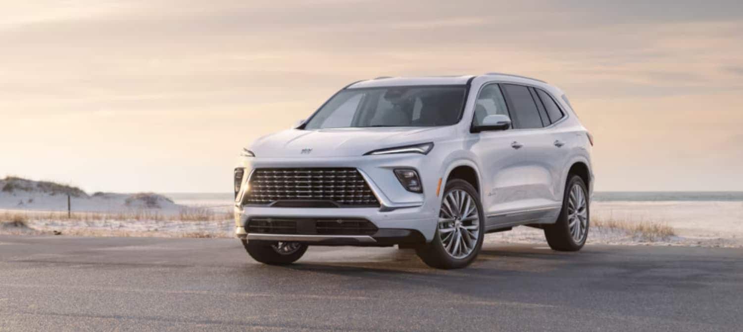 A white 2025 Buick Enclave parked on a beach.