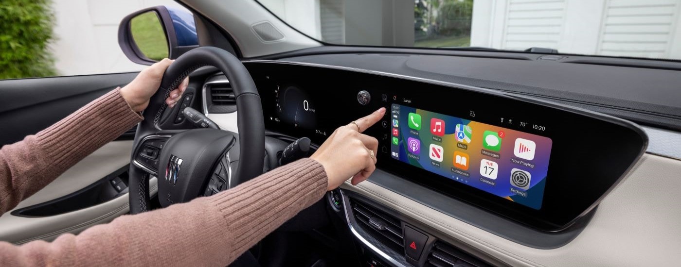 A driver using the infotainment system in their 2026 Buick Encore GX
