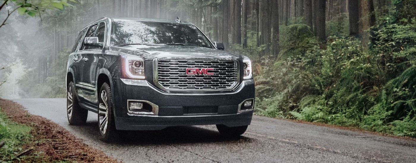 Black 2020 GMC Yukon Denali through a forest from a dealer with a used GMC for sale near Hialeah.