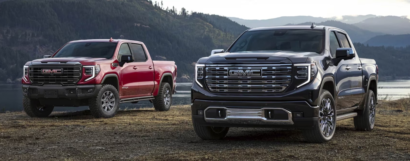 Black 2026 GMC Sierra 1500 Denali next to a red 2026 GMC Sierra 1500 AT4