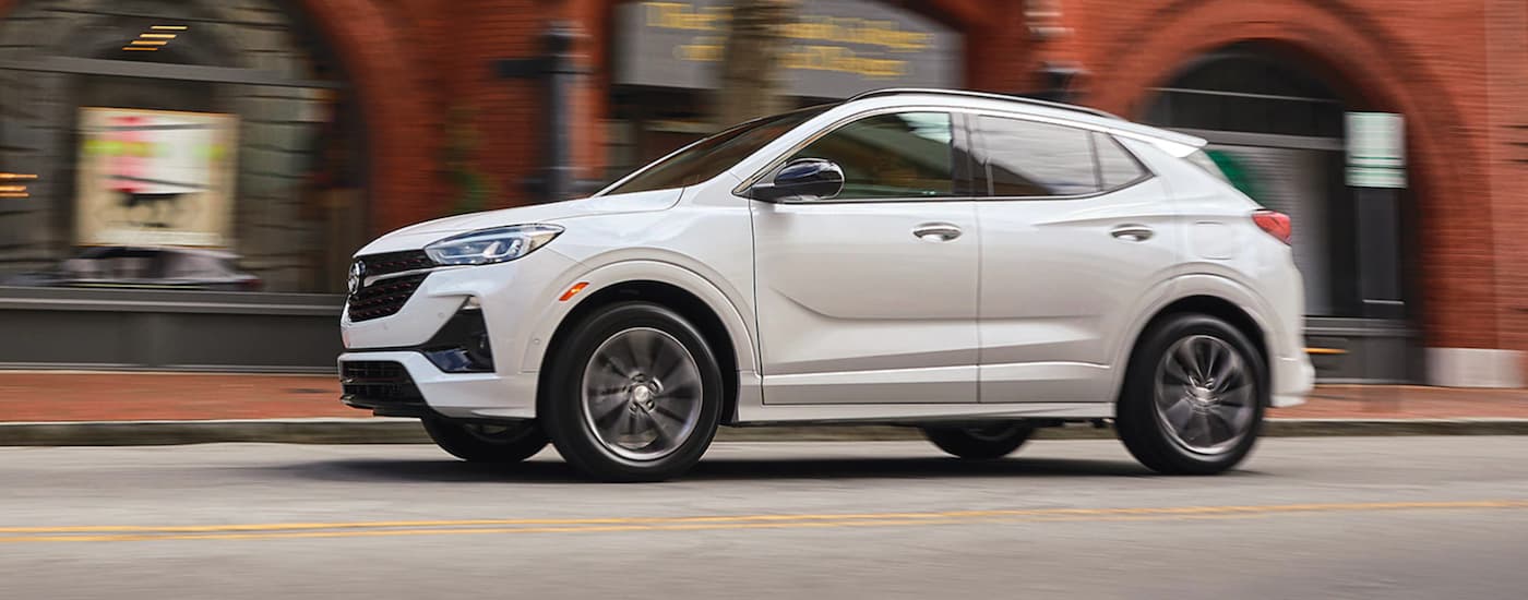 White 2021 Buick Encore GX driving through a town