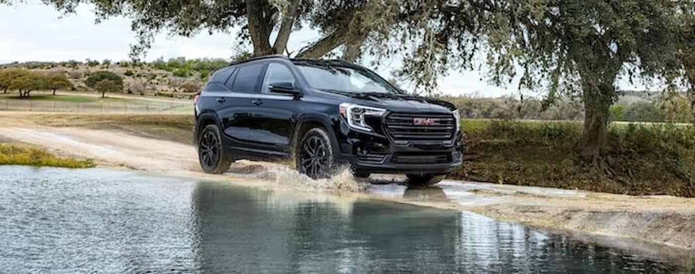 A black 2022 GMC Terrain off-roading after viewing a used GMC for sale neear Hollywood.