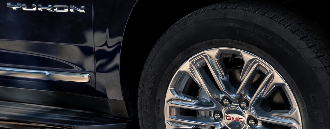Tire and side of a black 2024 GMC Yukon for sale in Miami.