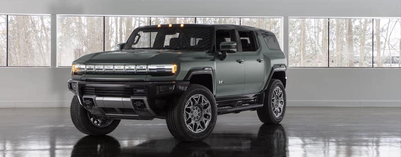 A green 2025 GMC Hummer EV from the front.