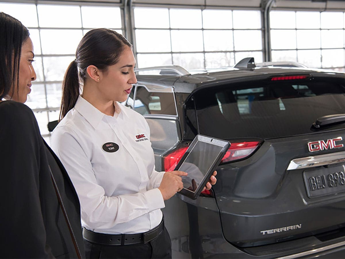Certified Service advisor reviewing repair and inspection results on a tablet at Brickell Buick GMC in Miami