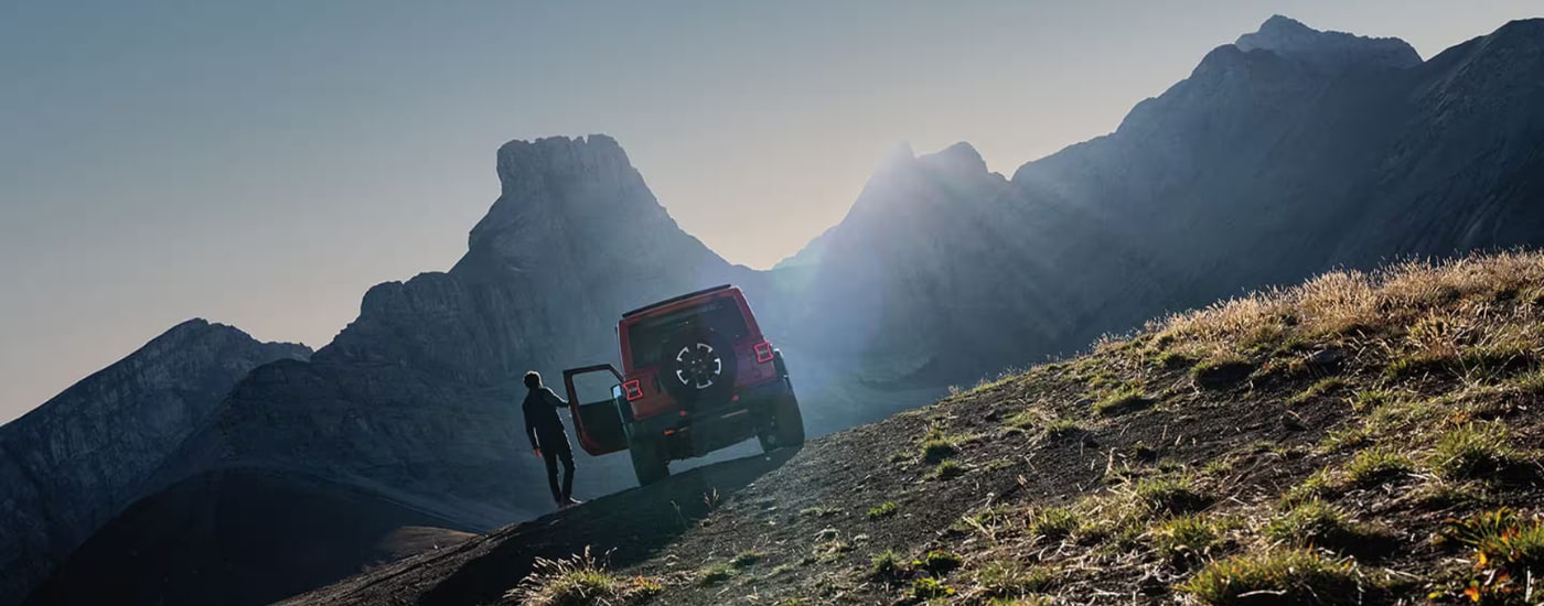 Red 2026 Jeep Wrangler parked on an incline