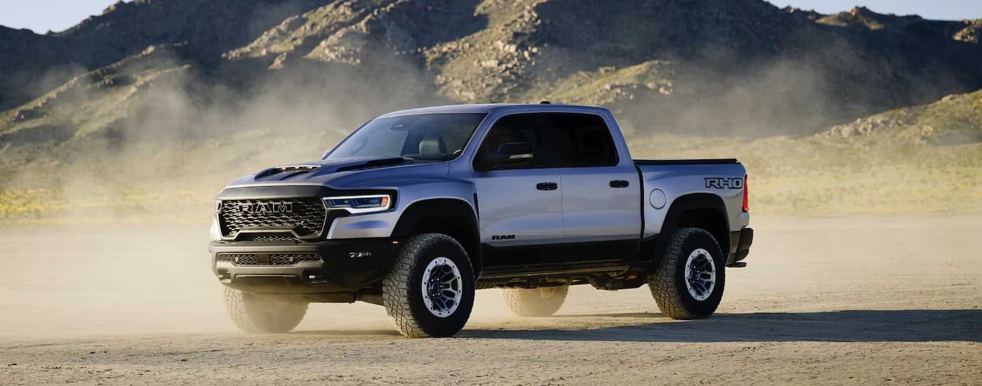 Silver 2025 Ram 1500 RHO parked off-road on dirt
