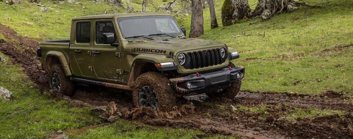A green 2025 Jeep Gladiator Rubicon off-roading.