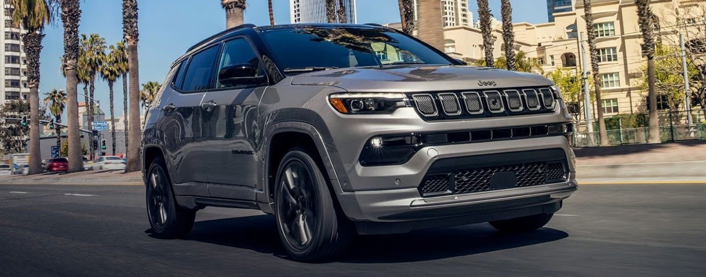 Grey 2024 Jeep Compass driving to a Jeep dealer in Miami