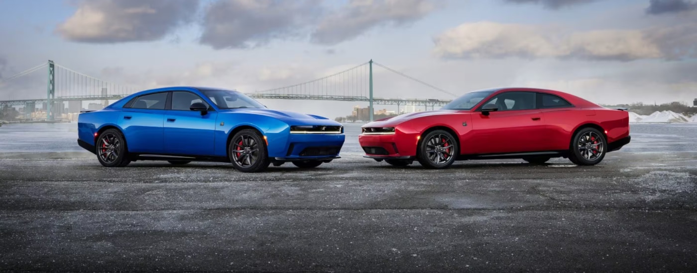 A red and a blue 2026 Dodge Chargers parked head to head