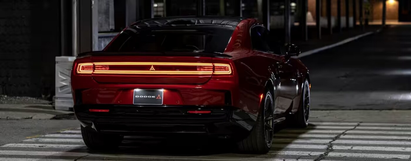 A red 2025 Dodge Charger driving to a Dodge dealer near Kendall.