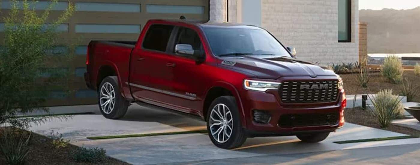 A red 2025 Ram 1500 parked in a driveway from a dealer near Doral
