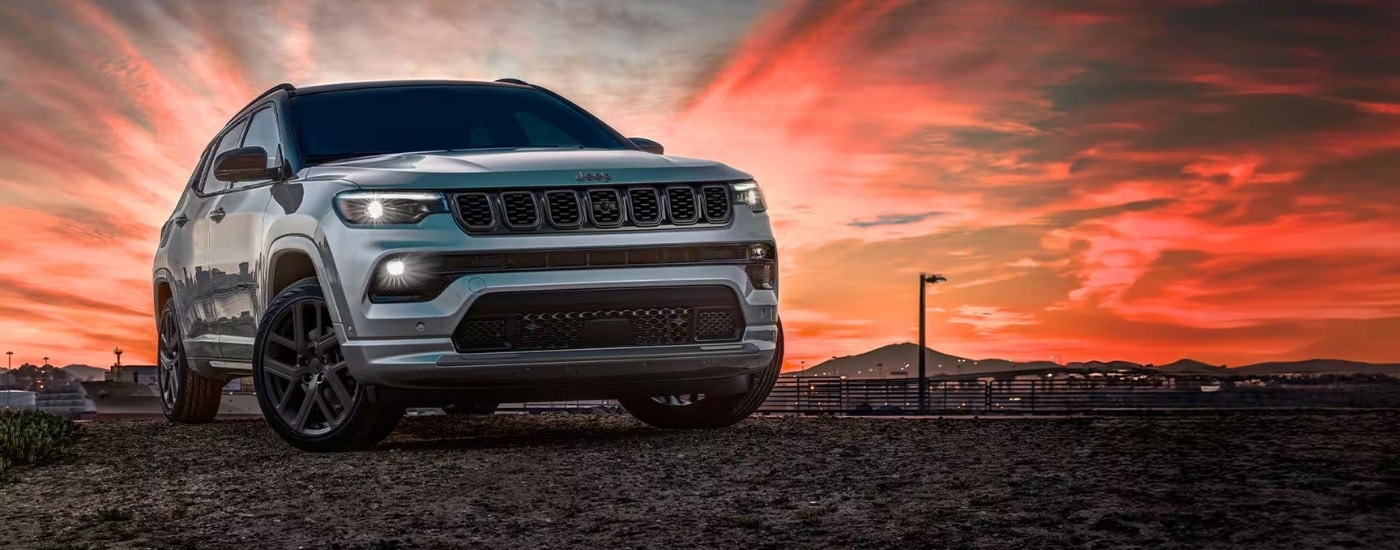 Silver 2025 Jeep Compass parked at an angle at sunset