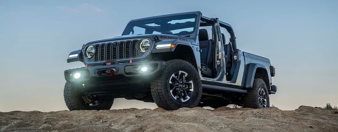 Grey 2026 Jeep Gladiator parked on top of a dune