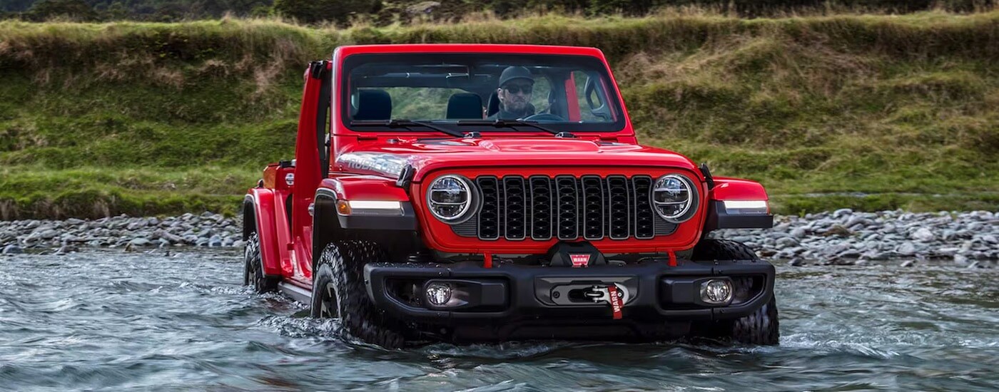A red 2023 Jeep Wrangler from the front.