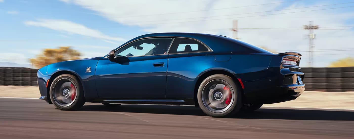 Blue 2025 Dodge Charger Daytona driving on a track