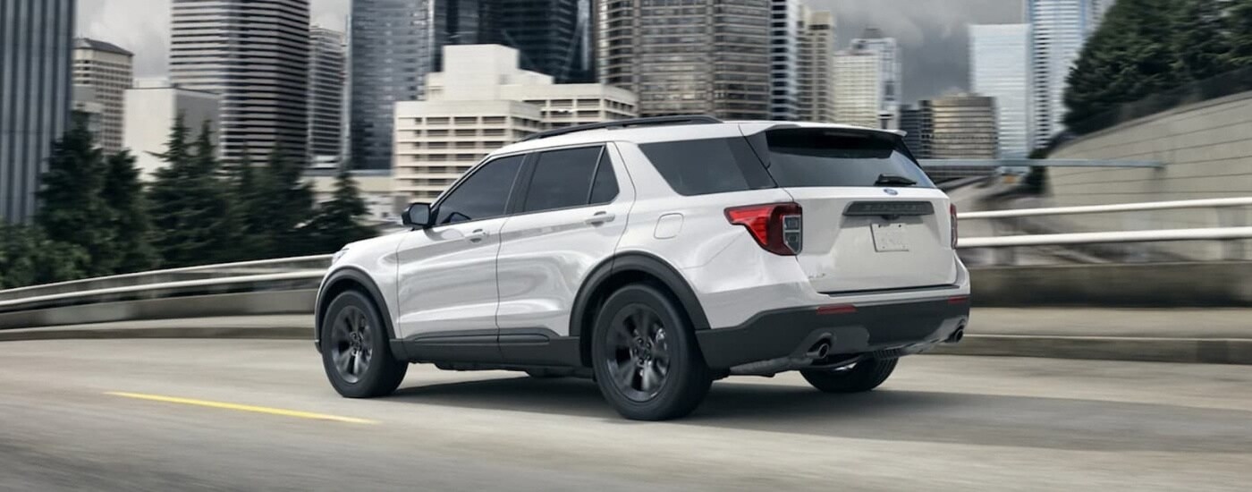 A white 2023 Ford Explorer from the rear at an angle.