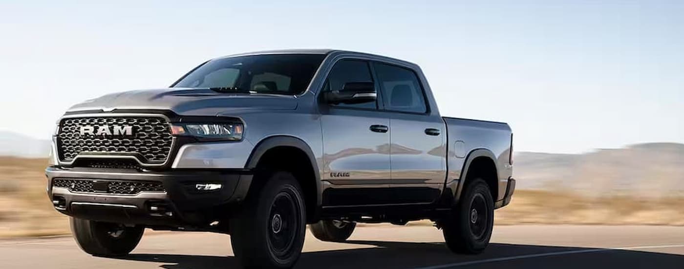 A silver 2025 Ram 1500 Shadow driving on a highway
