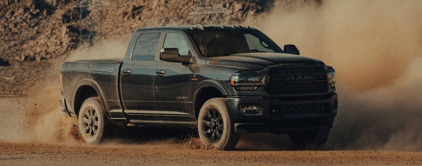 Black 2022 Ram 2500 drifting and kicking up dust