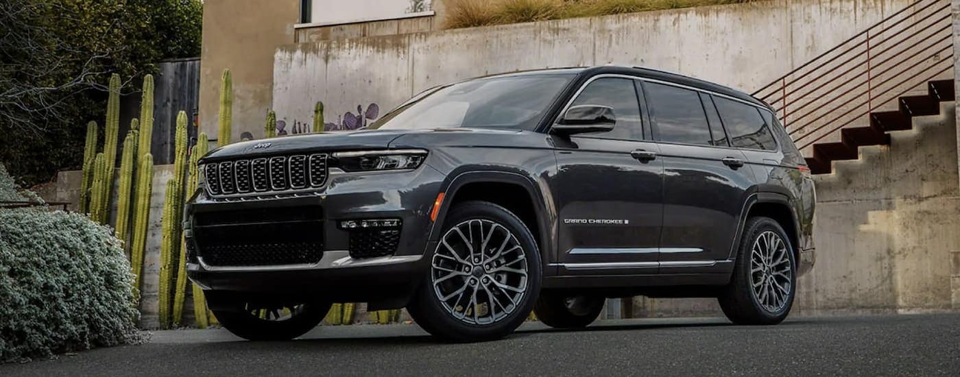 Black 2022 Jeep Grand Cherokee parked outside of a used car dealer near Doral