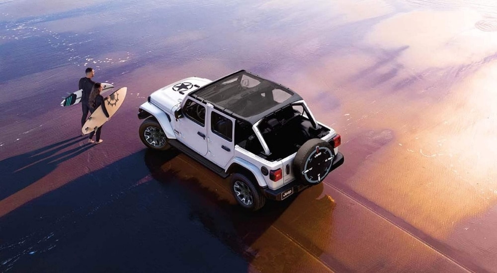 White 2026 Jeep Wrangler parked on a beach