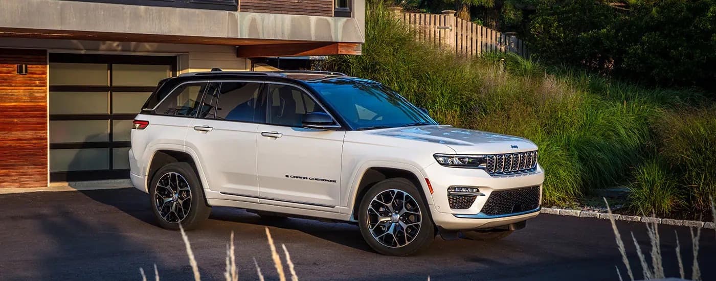 A white 2022 Jeep Grand Cherokee from the side after leaving a used car dealer near Hollywood.