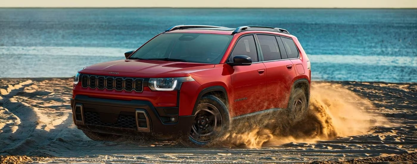 Red 2026 Jeep Cherokee kicking up sand