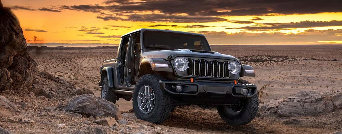 Grey 2026 Jeep Gladiator off-roading during sunset