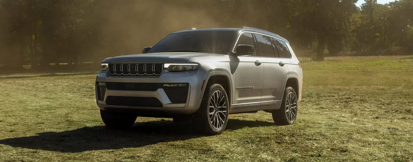 Silver 2026 Jeep Grand Cherokee parked at an angle on grass