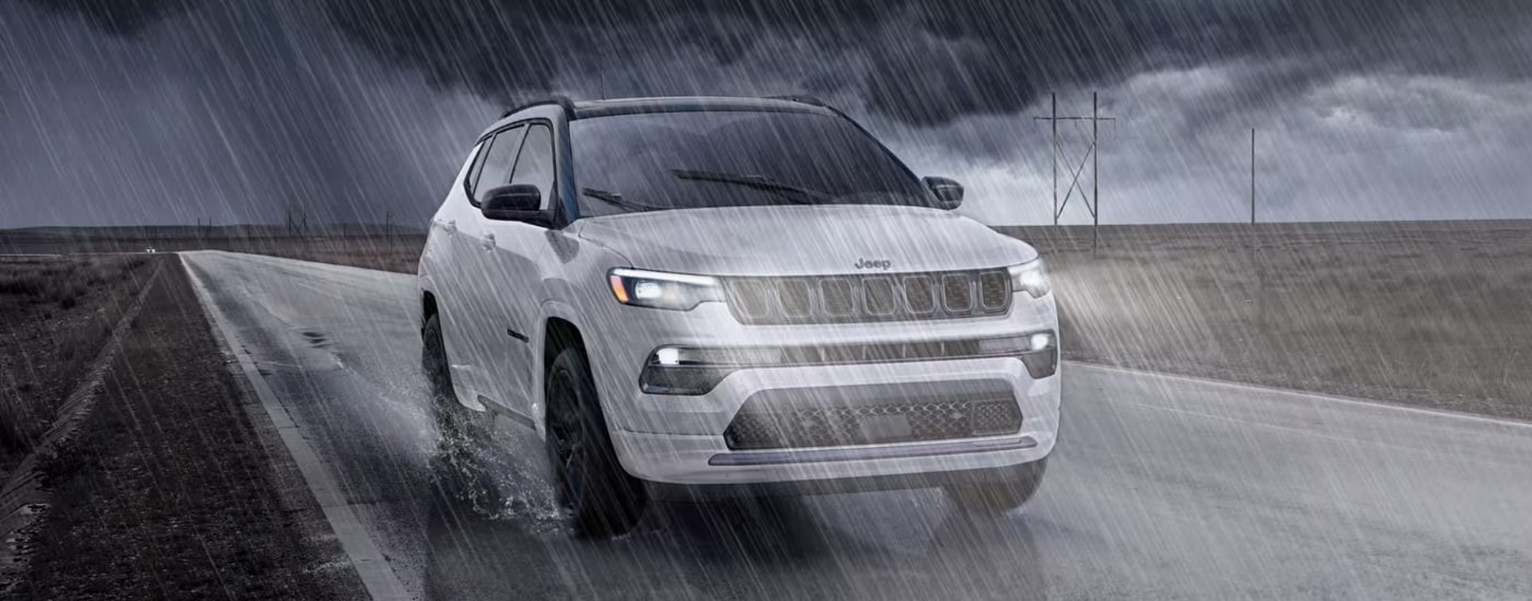 A white 2025 Jeep Compass from the front after leaving a Jeep dealer near North Miami.
