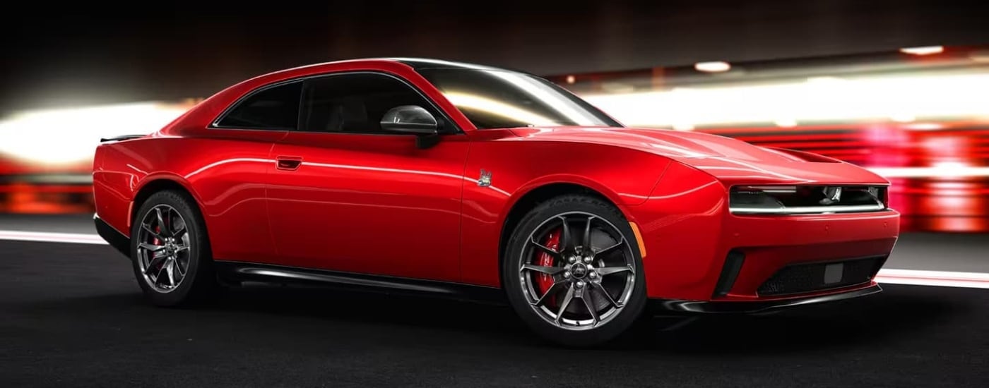 Red 2025 Dodge Charger Daytona for sale near Doral driving through a tunnel