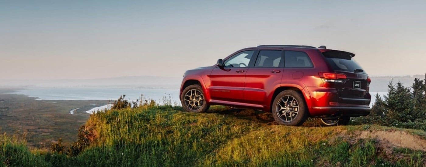 Red 2020 Jeep Grand Cherokee parked at an overlook
