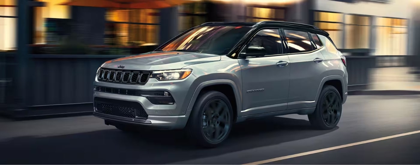 A silver 2025 Jeep Compass from ths side.