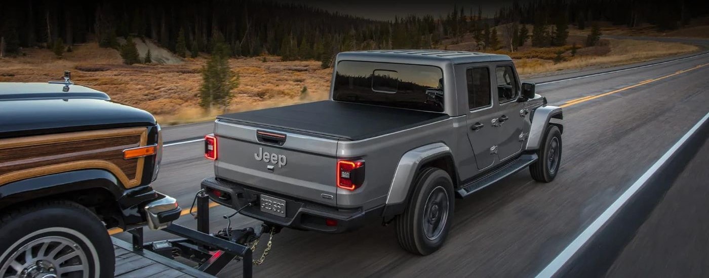 Silver 2022 Jeep Gladiator pulling a vehicle