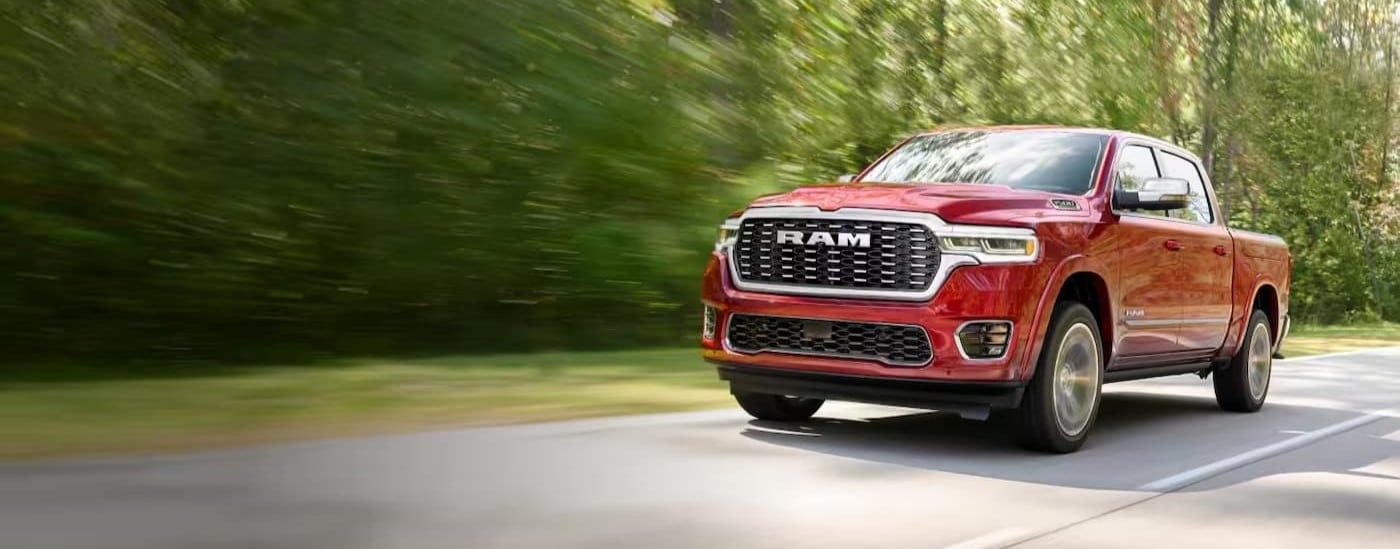 A red 2026 Ram 1500 for sale in Miami is driving on a highway.