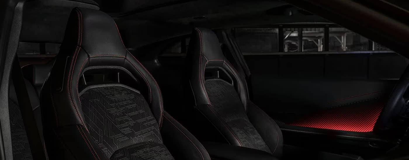 Black and red accented front seats in a 2025 Dodge Charger Daytona