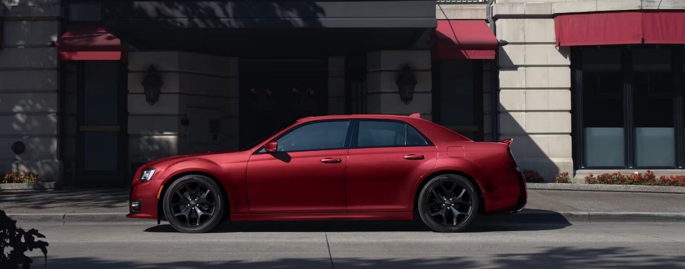 A red 2023 Chrysler 300s from the side.
