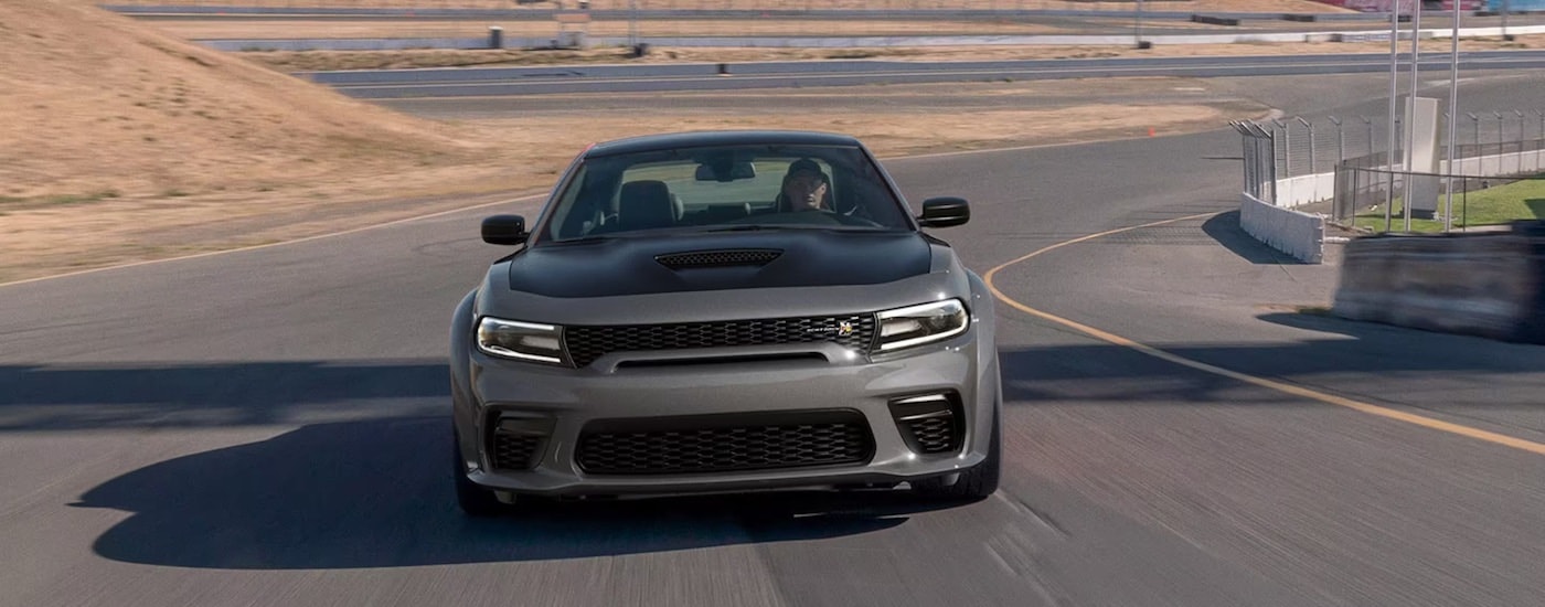 A grey 2023 Dodge Charger from the front after leaving a used car dealer in Miami.