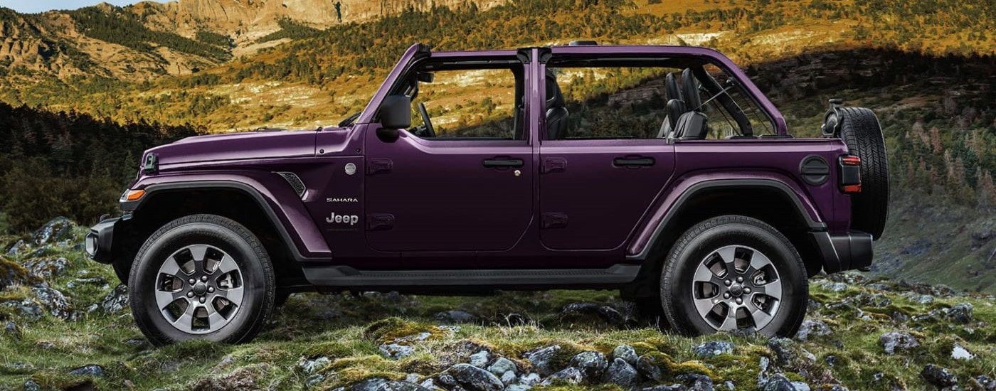 Side view of a purple 2023 Jeep Wrangler Sahara Unlimited