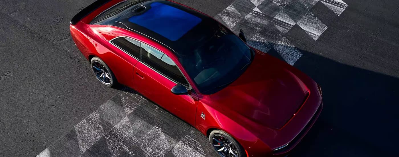 Red 2025 Dodge Charger Daytona parked on a starting line