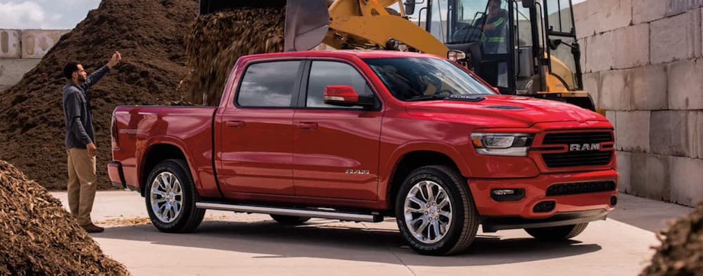Red 2021 Ram 1500 with the bed being loaded