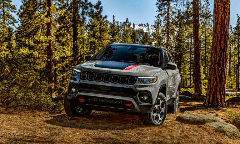 2022 Jeep Compass SUV driving off road inside a forest