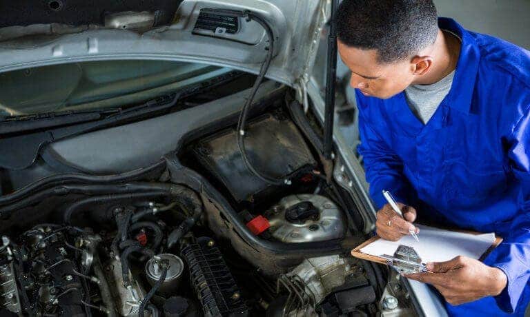 Technician examining vehicle in Merrill WI