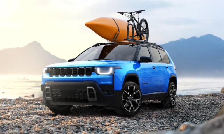 2026 Jeep Cherokee parked on beach with kayak